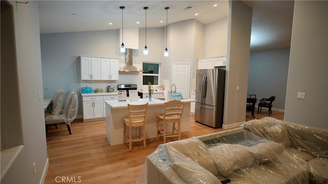 14610 Appleton St, Hesperia, CA 92345 - kitchen with freestanding refrigerator, wall chimney exhaust hood, high vaulted ceiling, white cabinets, and decorative backsplash