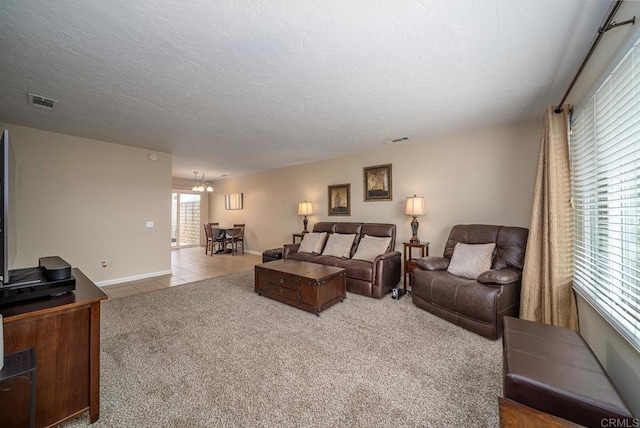 3567 Boussock Ln, Oceanside, CA 92057 - carpeted living room featuring visible vents, a textured ceiling, baseboards, and tile patterned floors