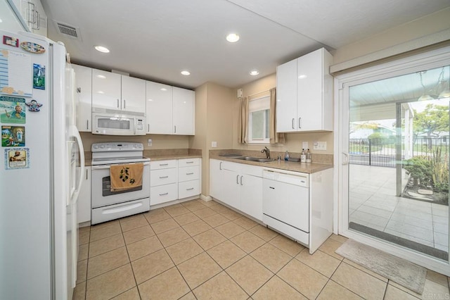 3567 Boussock Ln, Oceanside, CA 92057 - kitchen with visible vents, white appliances, light countertops, a sink, and light tile patterned floors