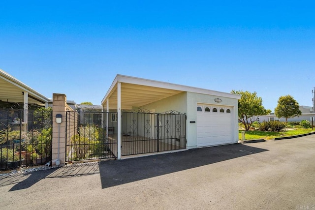 3567 Boussock Ln, Oceanside, CA 92057 - garage featuring fence, a gate, and aphalt driveway