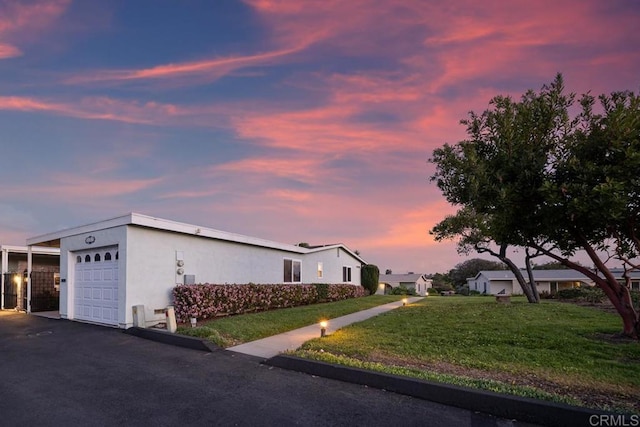 3567 Boussock Ln, Oceanside, CA 92057 - view of front facade featuring a lawn, an attached garage, stucco siding, and driveway