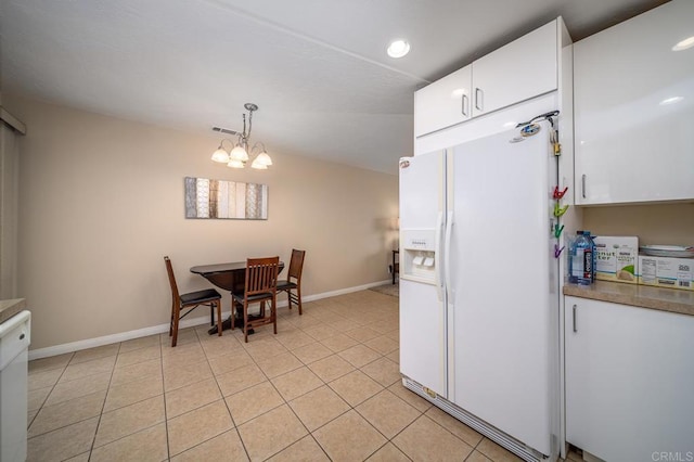 3567 Boussock Ln, Oceanside, CA 92057 - kitchen featuring white cabinets, an inviting chandelier, white fridge with ice dispenser, baseboards, and visible vents