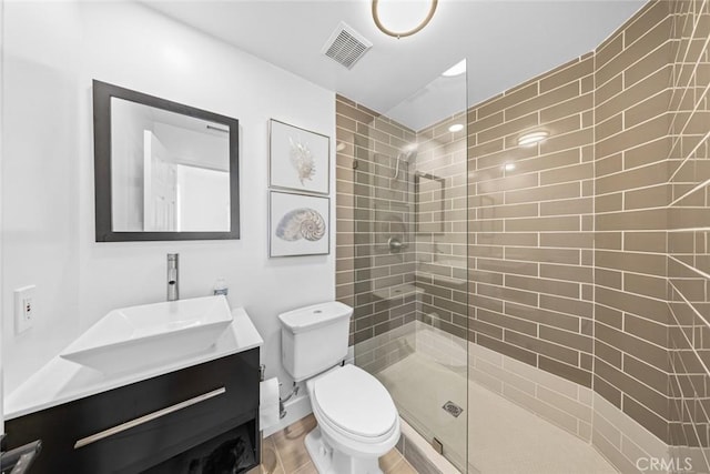 bathroom featuring visible vents, walk in shower, toilet, wood finished floors, and vanity