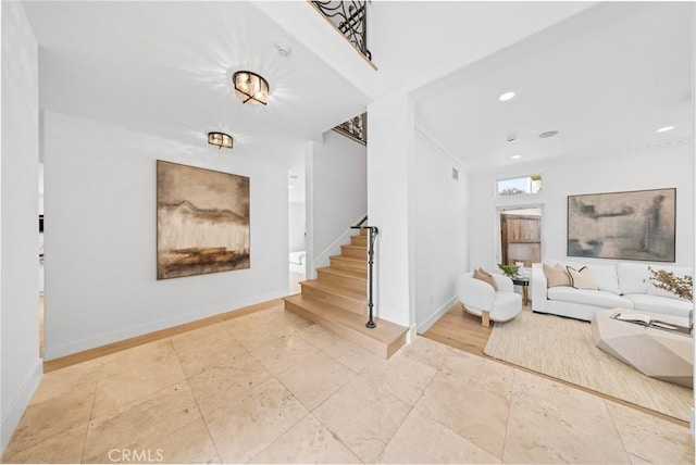 living room featuring recessed lighting, stairs, and baseboards