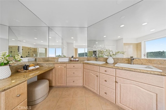 full bath featuring tile patterned floors, double vanity, a shower with door, and a sink