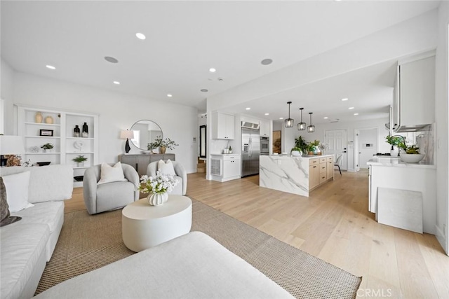 living room featuring recessed lighting and light wood-style flooring