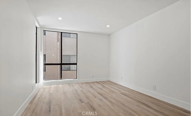 1250 S Beverly Glen Blvd Unit 205, Los Angeles, CA 90024 - unfurnished room with wood finished floors, baseboards, and recessed lighting
