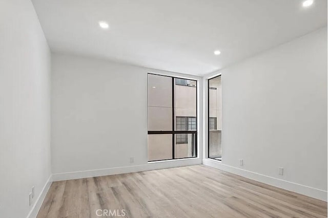 1250 S Beverly Glen Blvd Unit 205, Los Angeles, CA 90024 - empty room featuring light wood finished floors, baseboards, and recessed lighting