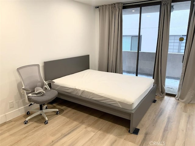 1250 S Beverly Glen Blvd Unit 205, Los Angeles, CA 90024 - bedroom with light wood-type flooring, access to exterior, and baseboards