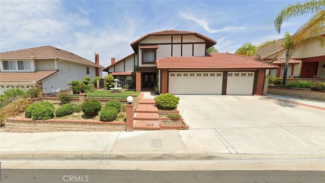 11537 Moonridge Dr, Whittier, CA 90601 - tudor house featuring an attached garage and concrete driveway