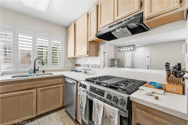 kitchen with light tile patterned flooring, stainless steel appliances, under cabinet range hood, a sink, and light brown cabinetry
