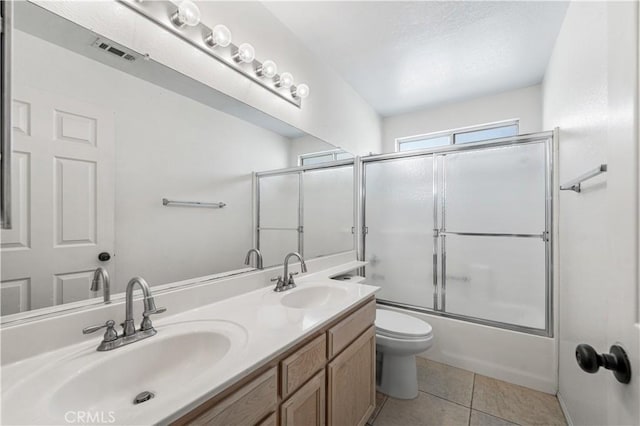full bath with double vanity, visible vents, a sink, and tile patterned flooring