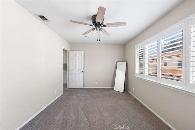 unfurnished bedroom with a ceiling fan, carpet floors, baseboards, and visible vents