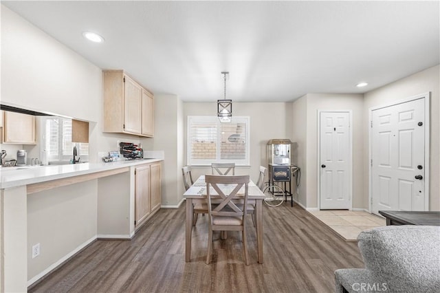dining room featuring baseboards, light wood-style flooring, and recessed lighting