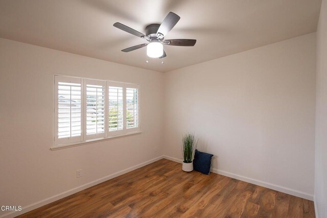 spare room with a ceiling fan, baseboards, and wood finished floors