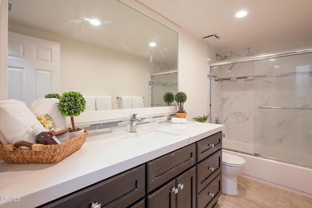 bathroom with vanity, recessed lighting, toilet, bath / shower combo with glass door, and visible vents