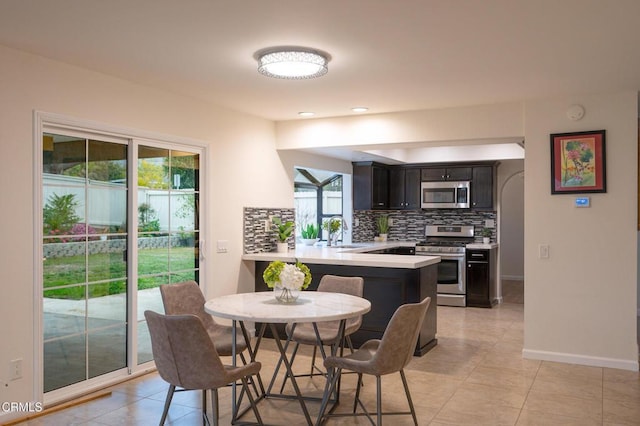 dining area featuring light tile patterned flooring and baseboards