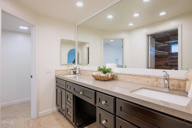 full bath featuring recessed lighting, backsplash, double vanity, and a sink
