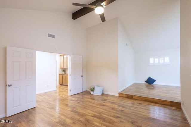 bonus room with light wood-type flooring, visible vents, baseboards, beamed ceiling, and ceiling fan