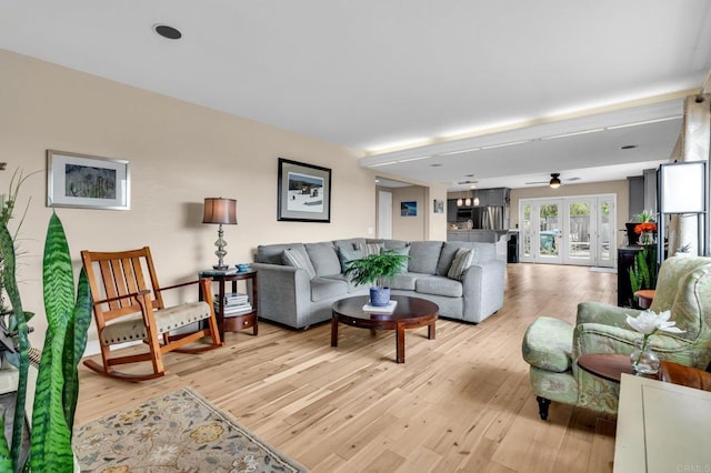 living area featuring light wood-style floors and a ceiling fan