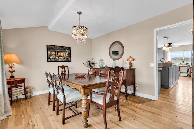 dining space with light wood finished floors, baseboards, and an inviting chandelier