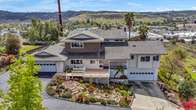 view of front of house featuring an attached garage, driveway, and a mountain view