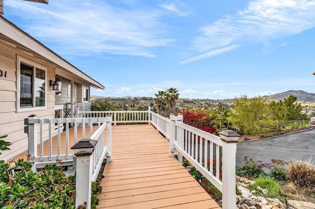 wooden deck with a mountain view