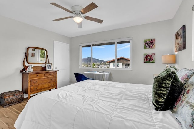 bedroom featuring wood finished floors and ceiling fan