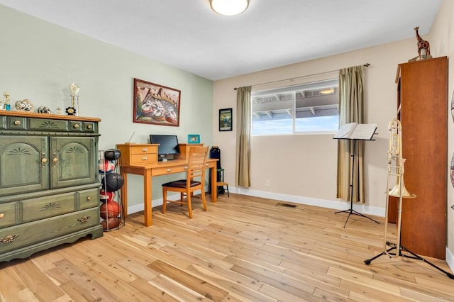 home office featuring light wood finished floors and baseboards