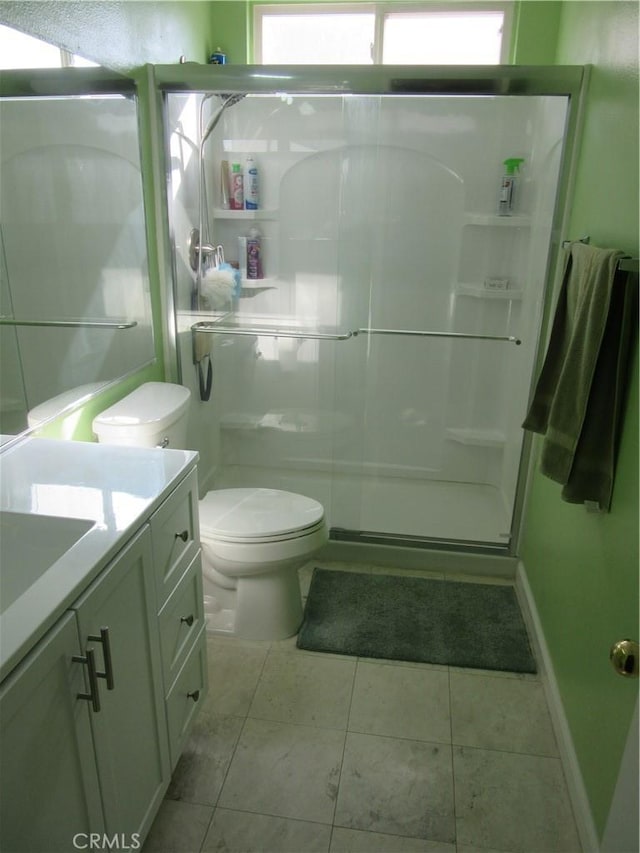 full bathroom with vanity, toilet, a healthy amount of sunlight, and a shower stall