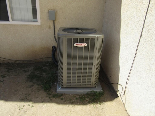 exterior details with central air condition unit and stucco siding