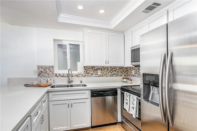 24311 Canyon Lake Dr N Unit 19, Canyon Lake, CA 92587 - kitchen with appliances with stainless steel finishes, a sink, a tray ceiling, light countertops, and white cabinetry