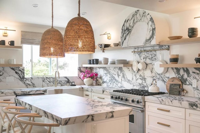 164 Chestnut Ave, Carlsbad, CA 92008 - kitchen featuring open shelves, stainless steel stove, white cabinets, a sink, and decorative backsplash