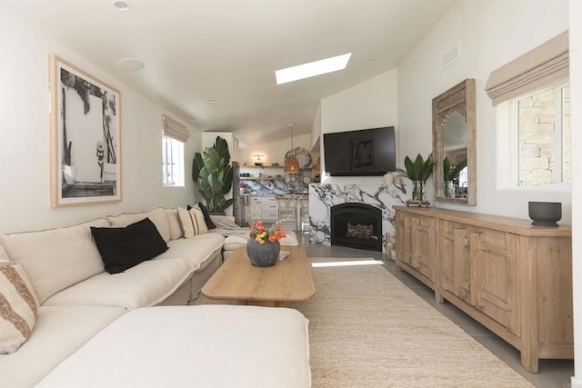 164 Chestnut Ave, Carlsbad, CA 92008 - living area featuring lofted ceiling, a high end fireplace, and a skylight