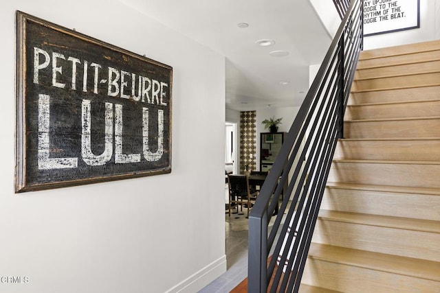 staircase featuring baseboards and recessed lighting