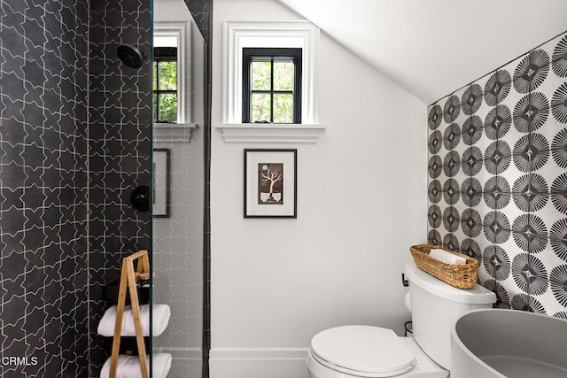 full bathroom featuring baseboards, vaulted ceiling, toilet, and walk in shower