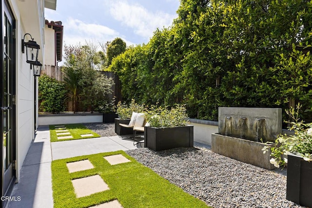 view of yard featuring fence and a patio