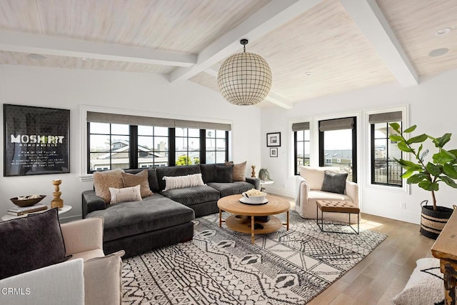 living area featuring wood ceiling, vaulted ceiling with beams, baseboards, and wood finished floors