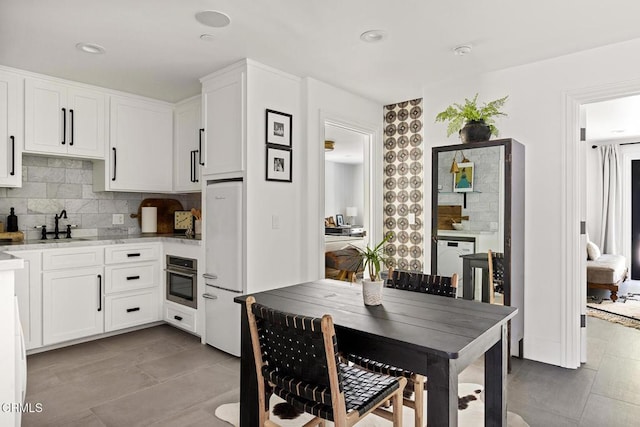 dining space featuring light tile patterned flooring and recessed lighting