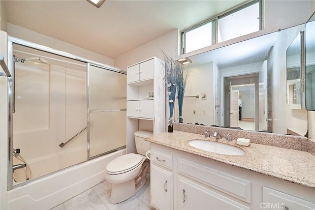 full bathroom featuring enclosed tub / shower combo, toilet, tile patterned flooring, and vanity