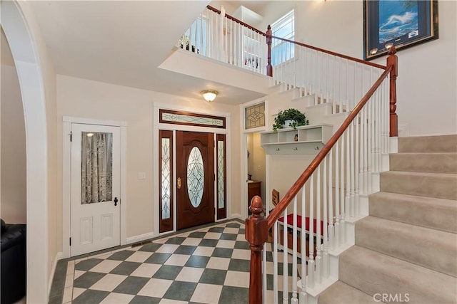 27601 Cedarwood Dr, Lake Arrowhead, CA 92352 - entrance foyer featuring stairway, a high ceiling, and baseboards
