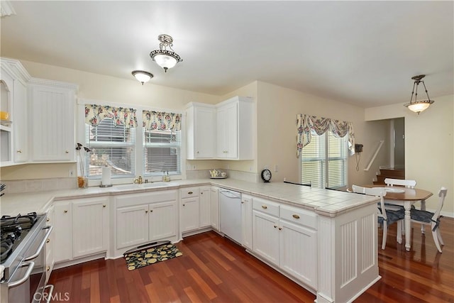 27601 Cedarwood Dr, Lake Arrowhead, CA 92352 - kitchen featuring a peninsula, dark wood-style flooring, gas stove, white cabinetry, and white dishwasher