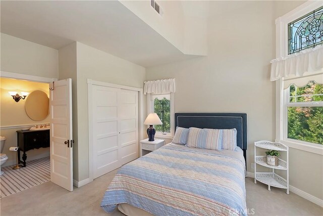 27601 Cedarwood Dr, Lake Arrowhead, CA 92352 - bedroom with light carpet, baseboards, a closet, and visible vents