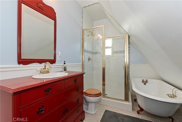 27601 Cedarwood Dr, Lake Arrowhead, CA 92352 - bathroom with a shower stall, tile patterned flooring, vanity, a freestanding tub, and vaulted ceiling