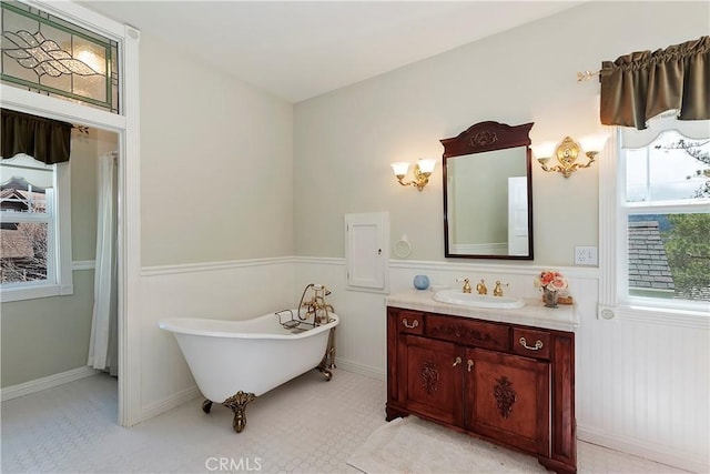 27601 Cedarwood Dr, Lake Arrowhead, CA 92352 - bathroom with a soaking tub, a wainscoted wall, and vanity