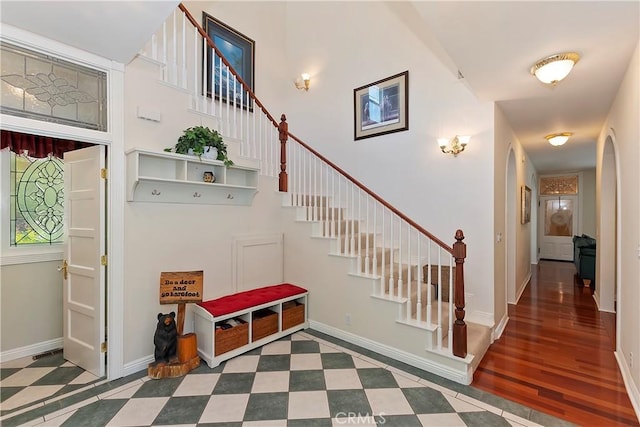 27601 Cedarwood Dr, Lake Arrowhead, CA 92352 - mudroom with baseboards, a towering ceiling, and arched walkways