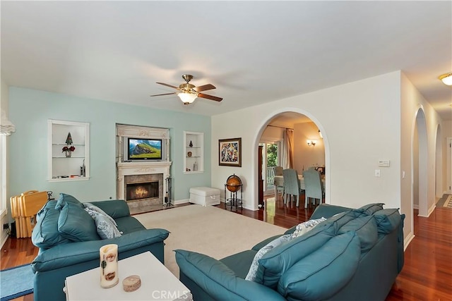 27601 Cedarwood Dr, Lake Arrowhead, CA 92352 - living area featuring a ceiling fan, baseboards, dark wood finished floors, built in features, and arched walkways