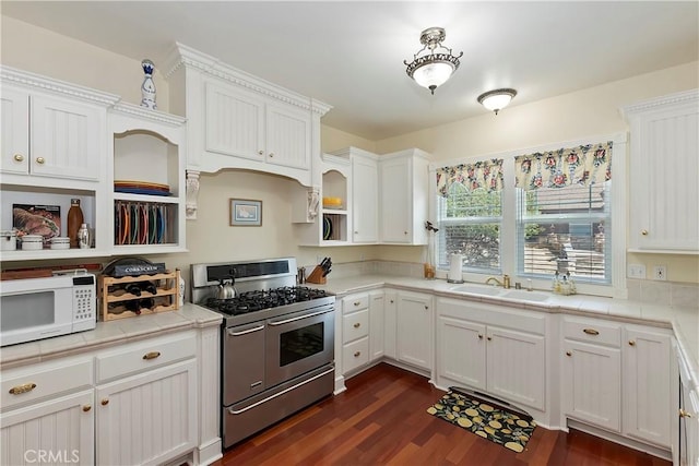 27601 Cedarwood Dr, Lake Arrowhead, CA 92352 - kitchen with range with two ovens, white microwave, white cabinetry, and a sink