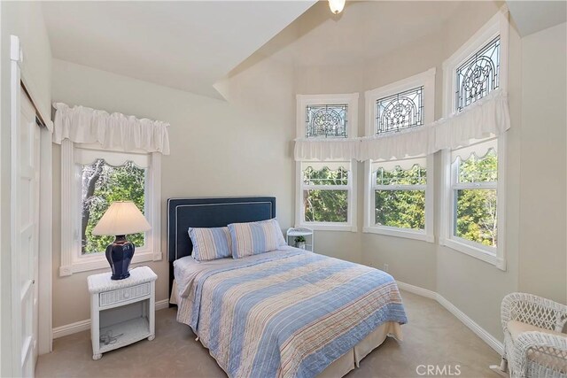 27601 Cedarwood Dr, Lake Arrowhead, CA 92352 - carpeted bedroom featuring a towering ceiling, baseboards, and multiple windows