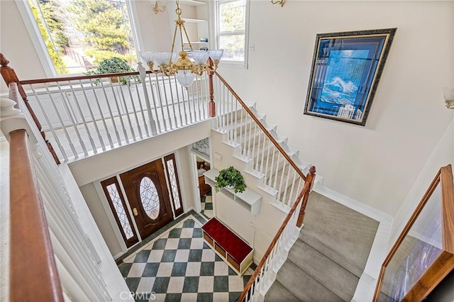 27601 Cedarwood Dr, Lake Arrowhead, CA 92352 - entrance foyer featuring stairway, an inviting chandelier, and a high ceiling